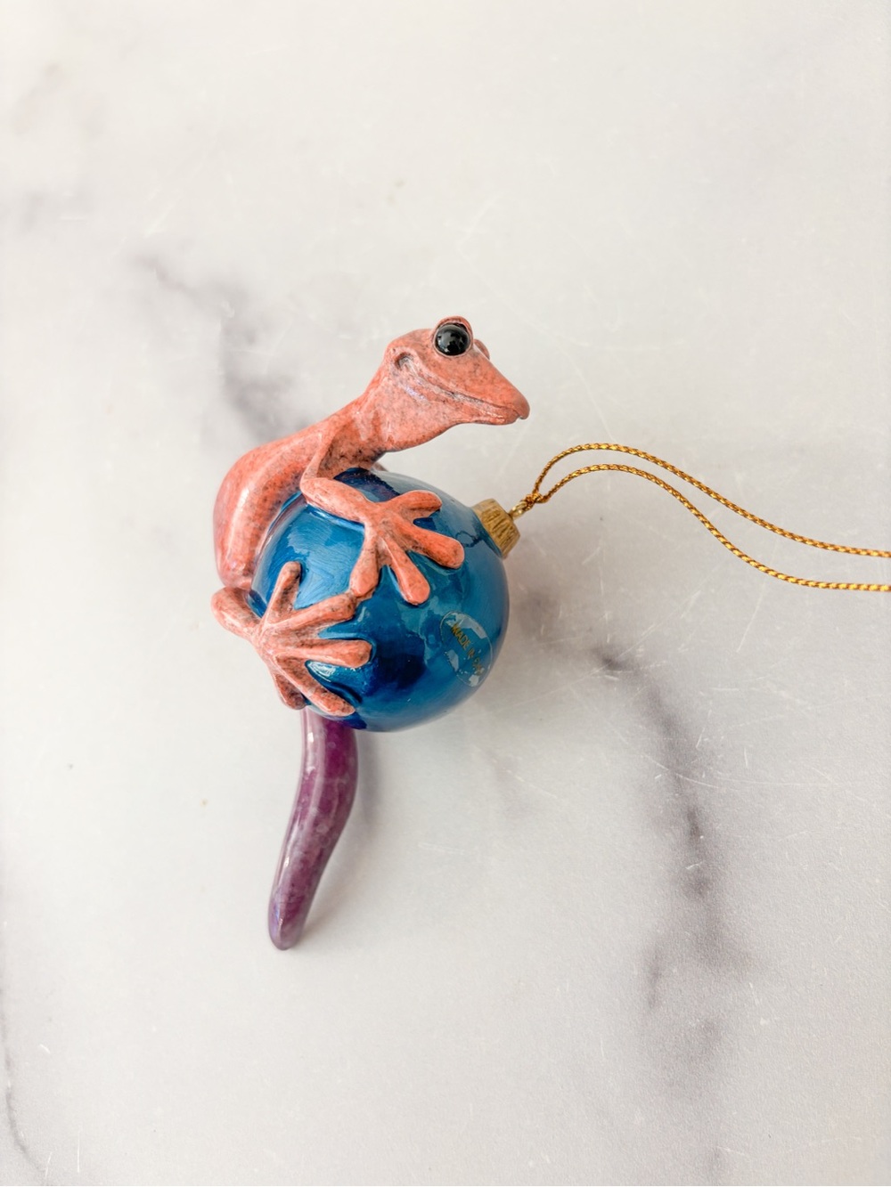 Kitty’s Critters Oops Pink Gecko Holding on Blue Ball Ornament